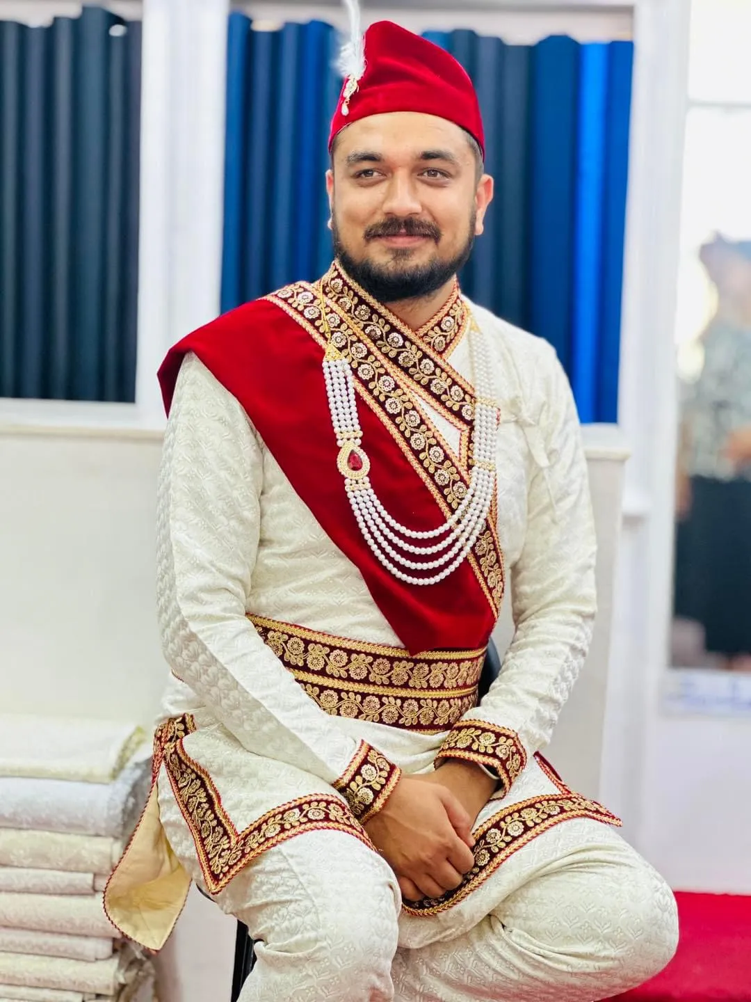 Traditional Daura Suruwal in cream with crimson sash
